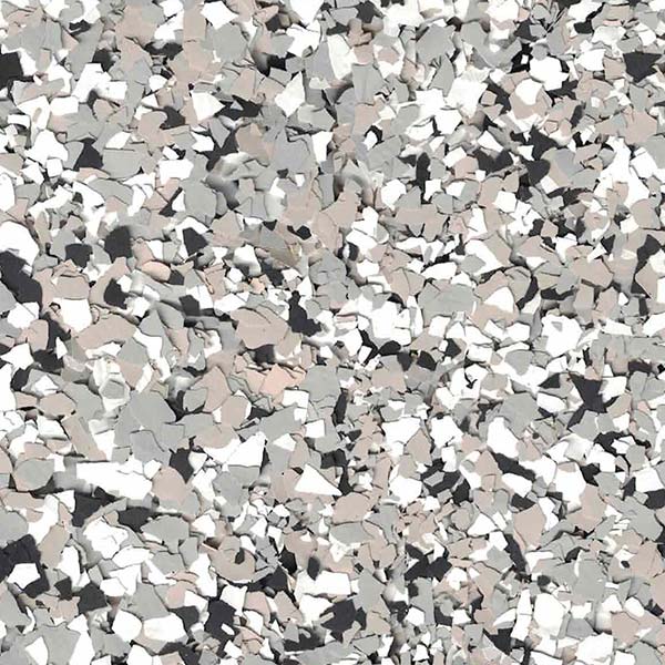 The image shows a close-up of a terrazzo surface featuring an assortment of small, irregularly shaped chips in shades of gray, white, and black.