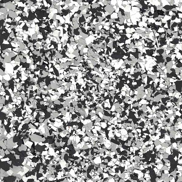 This image shows a large number of irregularly shaped particles in various shades of gray, densely packed together to create a chaotic mosaic texture.