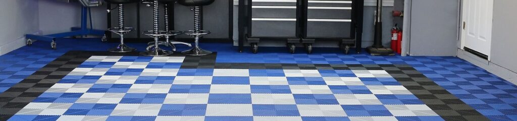This image shows an organized gym area with blue and black checkered flooring, various weight machines, a dumbbell rack, and a fire extinguisher.